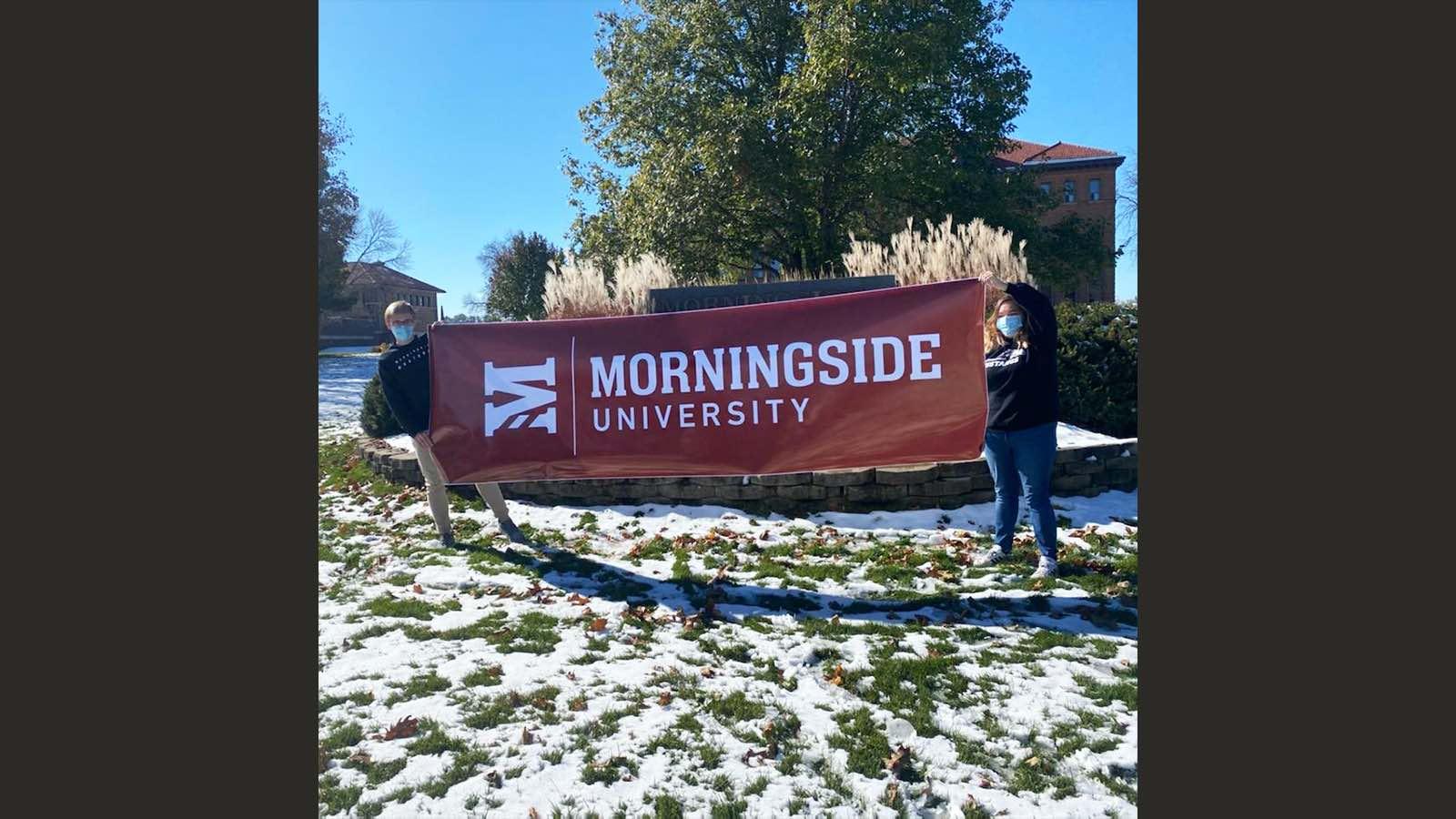 Students with Mside U sign